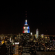 The Empire State Building is lit red, white, and blue.